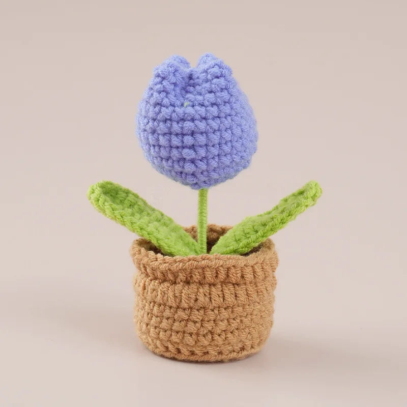 Handcrafted crochet purple tulip flower growing in a brown woven pot