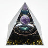 Handmade resin orgonite pyramid featuring a purple stone, natural obsidian, and a copper coil.