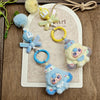 A set of cute heart plush keychain charms in blue and yellow, featuring a fluffy pom-pom and a stylized heart design.