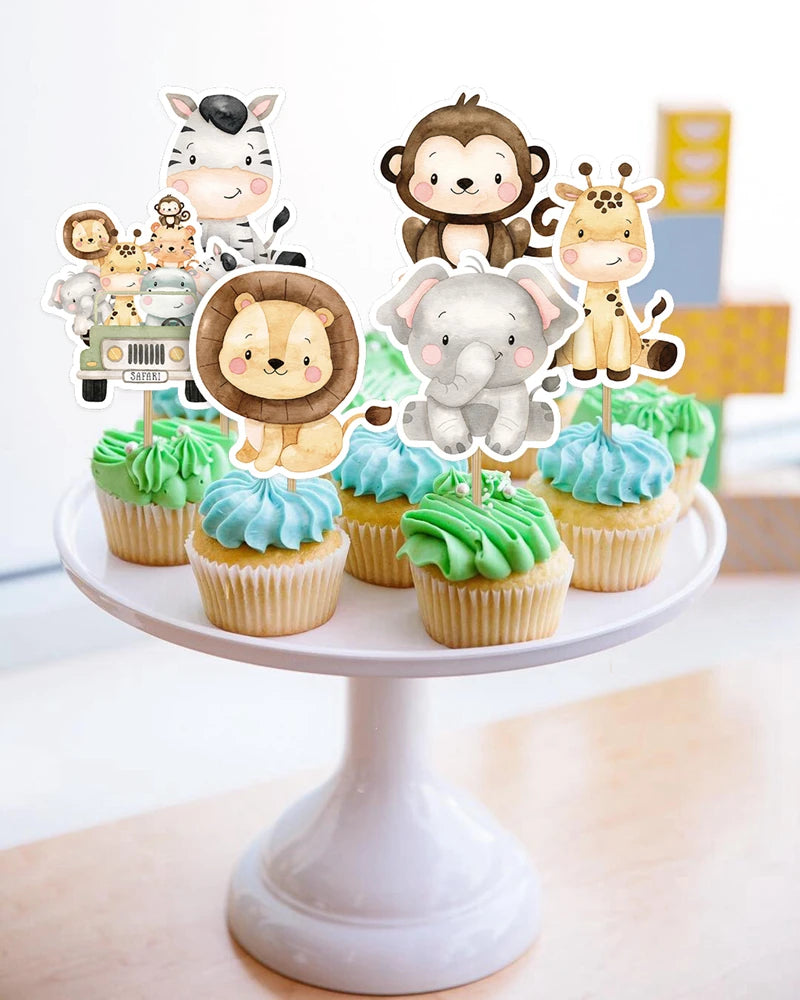 A display of jungle animal cake toppers featuring monkeys, elephants, and other animals on a white cake stand.