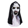 A realistic horror nun latex mask with pale skin, yellow eyes, and a wide, menacing smile.