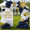 A balloon arch display featuring navy blue, white, and gold balloons for a graduation celebration.