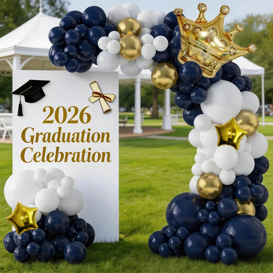 A balloon arch display featuring navy blue, white, and gold balloons for a graduation celebration.