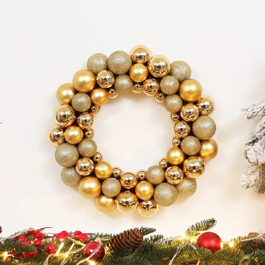 A circular wreath made of gold and champagne-colored glittered Christmas balls.