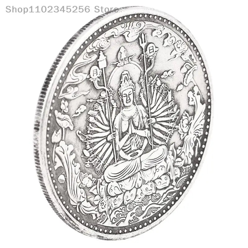 Silver-toned medallion featuring a seated Buddha figure with multiple arms and religious symbols.
