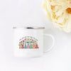 A white enamel mug with a floral design and the word TEACHER printed on it, set against a white background.