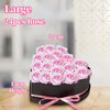 A large bouquet of 24 pink roses in a black box tied with a pink ribbon.