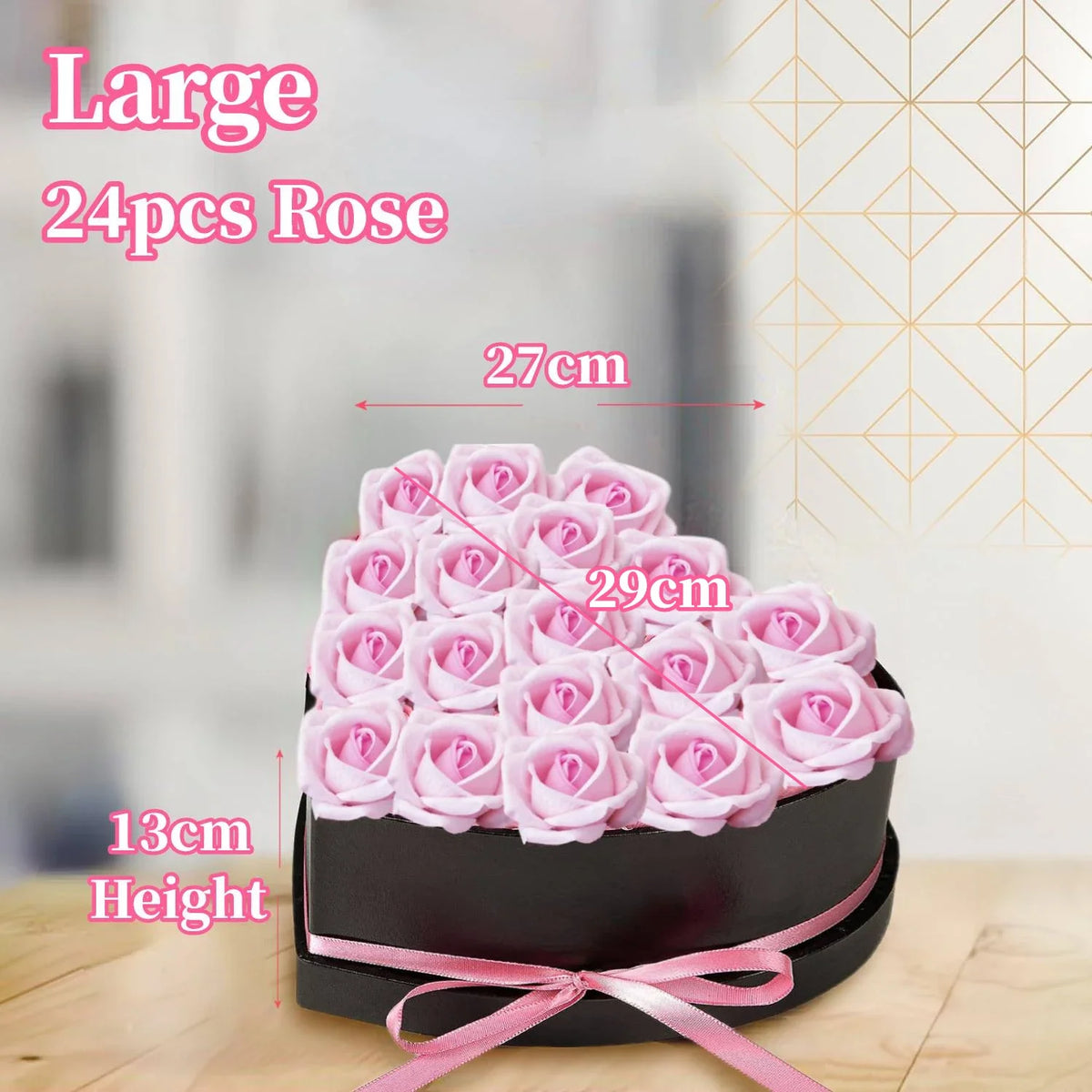 A large bouquet of 24 pink roses in a black box tied with a pink ribbon.