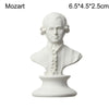 White plaster bust miniature of Mozart with powdered hair and ruffled collar.