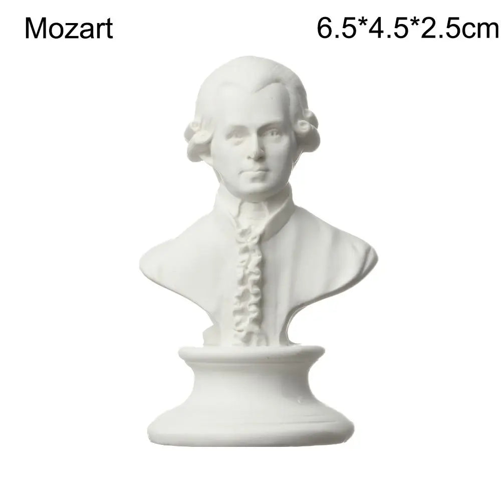 White plaster bust miniature of Mozart with powdered hair and ruffled collar.