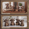 A set of rustic wooden Highland cow figurines shaped like letters H, M, E, and another letter E, displayed in framed pictures