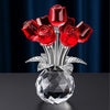 A crystal rose decorative flower arrangement featuring red roses on a silver stem and clear glass base.