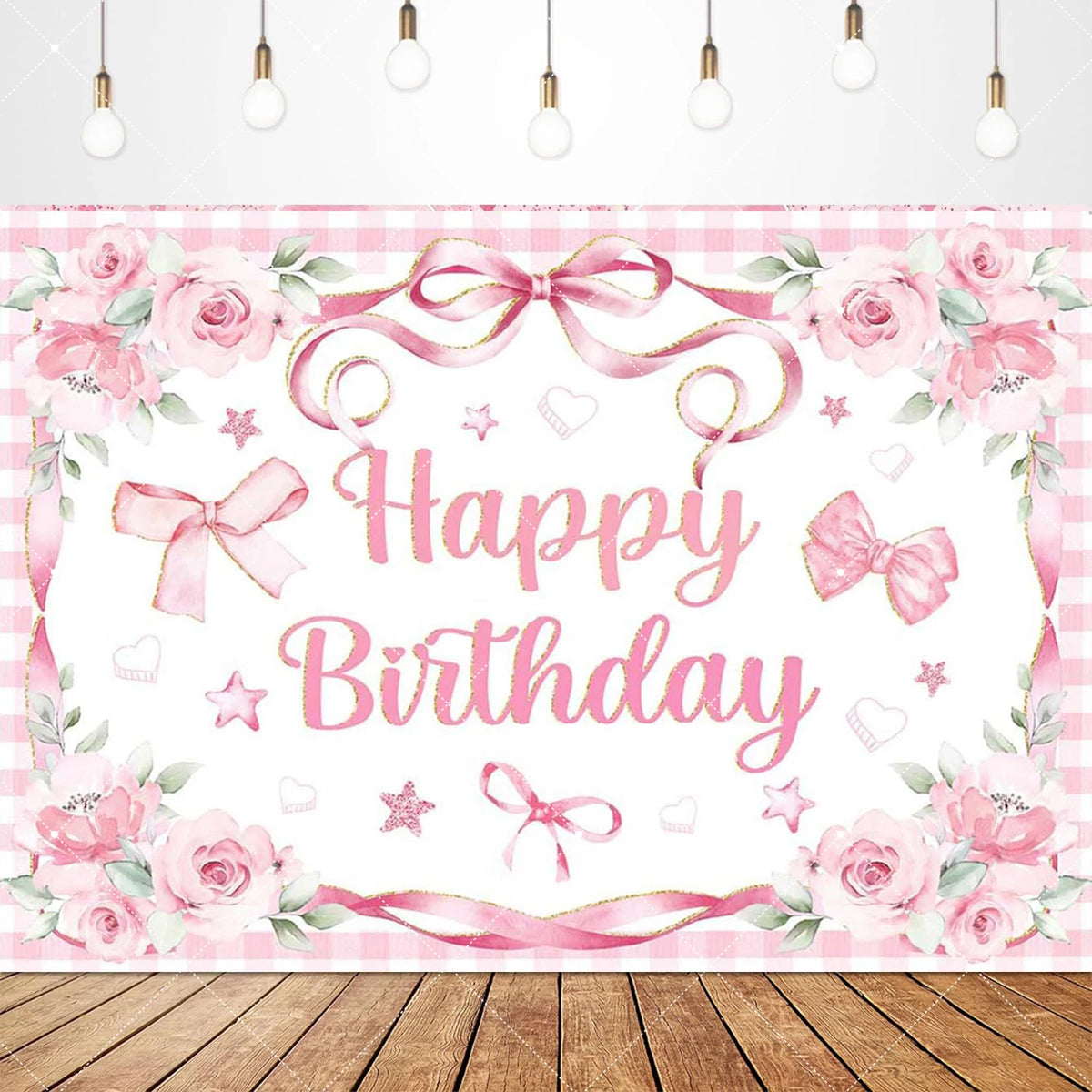 A pink and white floral birthday banner featuring a bow ribbon design on a wooden surface.