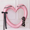 Pink heart-shaped balloon decoration with Happy and Birthday text