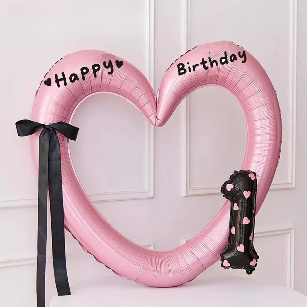 Pink heart-shaped balloon decoration with Happy and Birthday text