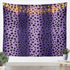 A purple leopard print tapestry wall hanging decorated with warm string lights.