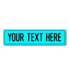 A rectangular turquoise metal street sign with the text YOUR TEXT HERE in black capital letters.