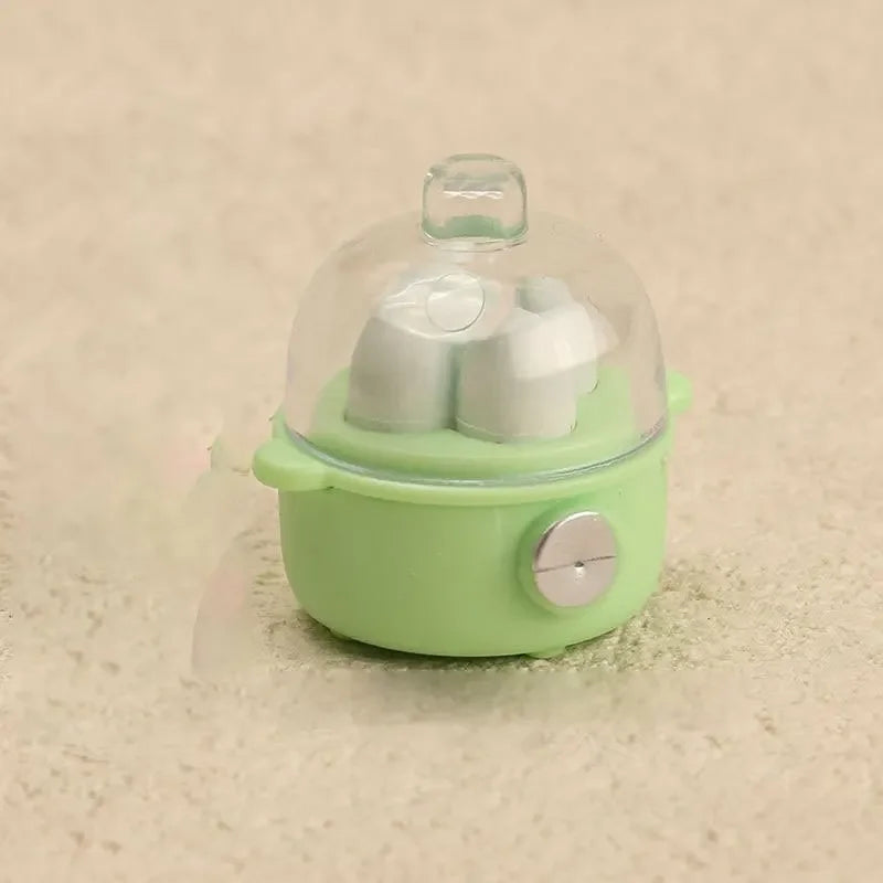 A small, light green kitchen appliance dollhouse accessory with a clear dome and white components.