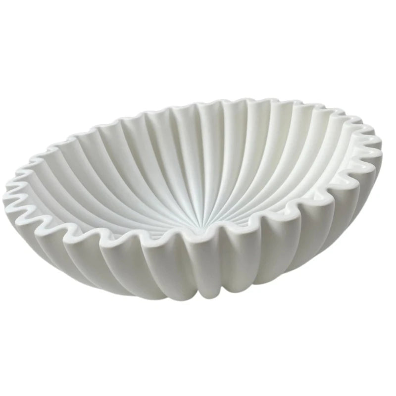 A white modern ruffle scalloped decorative bowl with vertical fluting.
