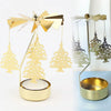 Gold rotating candle holder with a spinning carousel design featuring delicate gold-colored Christmas tree shapes.
