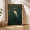 A vertical canvas print of a white crane against a dark teal background, framed in gold.