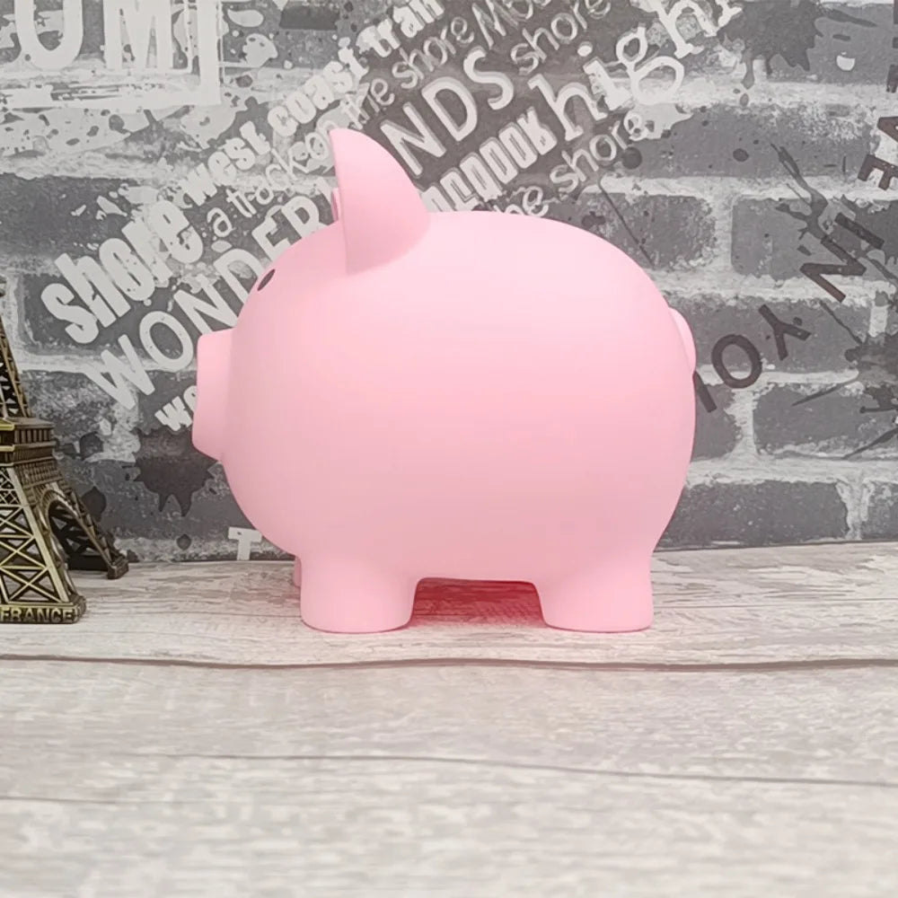 A pink piggy bank is sitting on a wooden surface against a brick wall background.