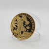 A round gold commemorative iron coin featuring a figure and celestial elements on a black background.