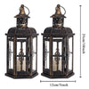 A vintage Nordic iron candle lantern with glass panes, featuring a dark finish and decorative metal top.