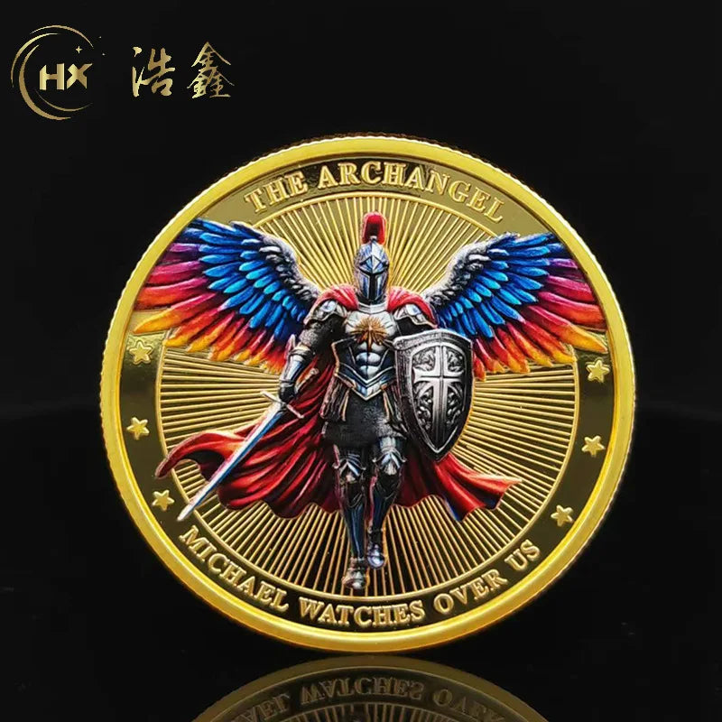 A gold medal coin featuring a winged warrior design with the text The Archangel and Michael Watches Over Us
