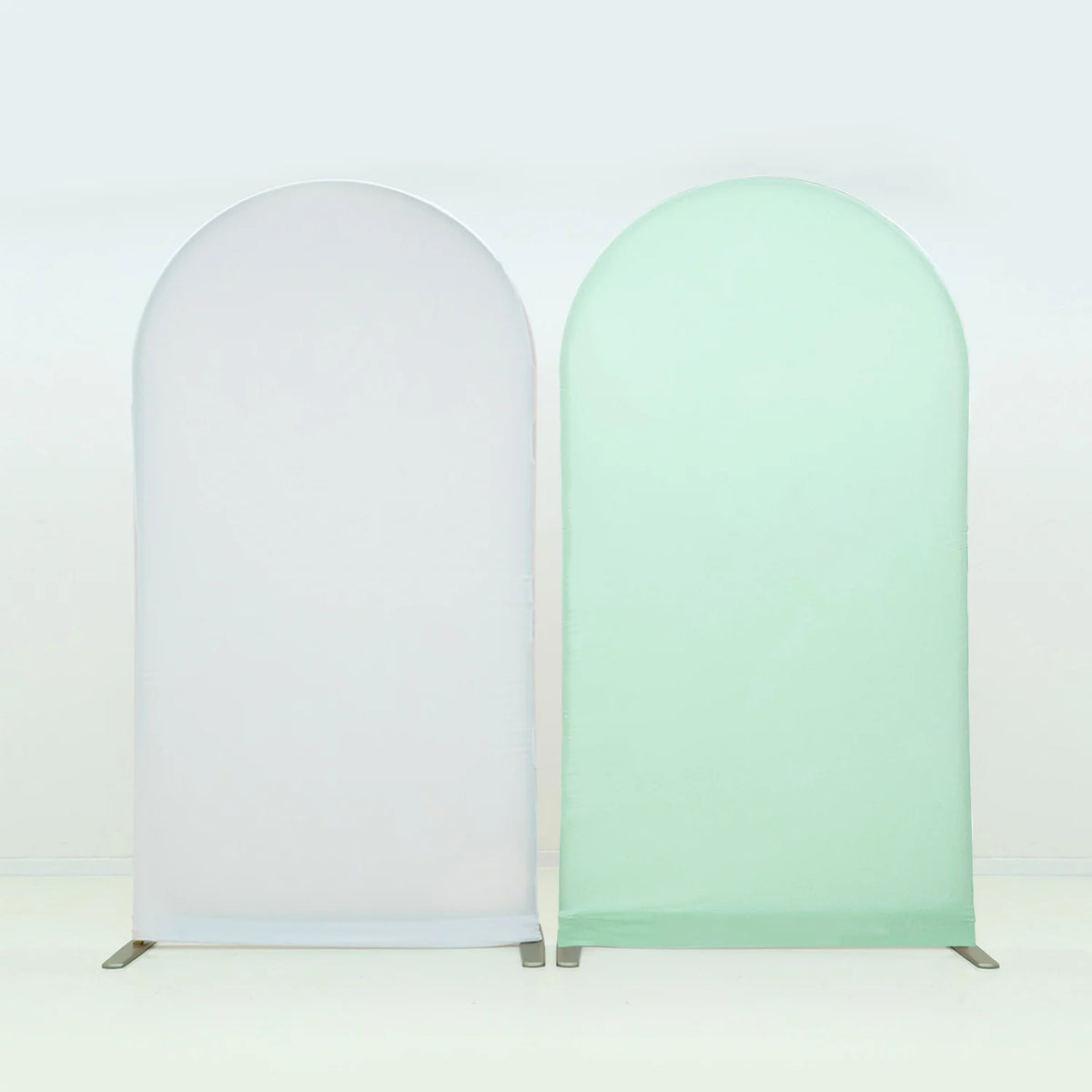 A pair of light green and white stretchable arch backdrop covers for party and event decor.