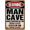A vintage metal warning sign with red and white text that reads WARNING MAN CAVE.