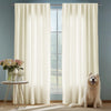 Light beige natural linen sheer curtains hanging in a window with a fluffy dog sitting nearby