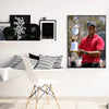 A framed canvas wall art portrait of Tiger Woods in a red polo shirt and cap.