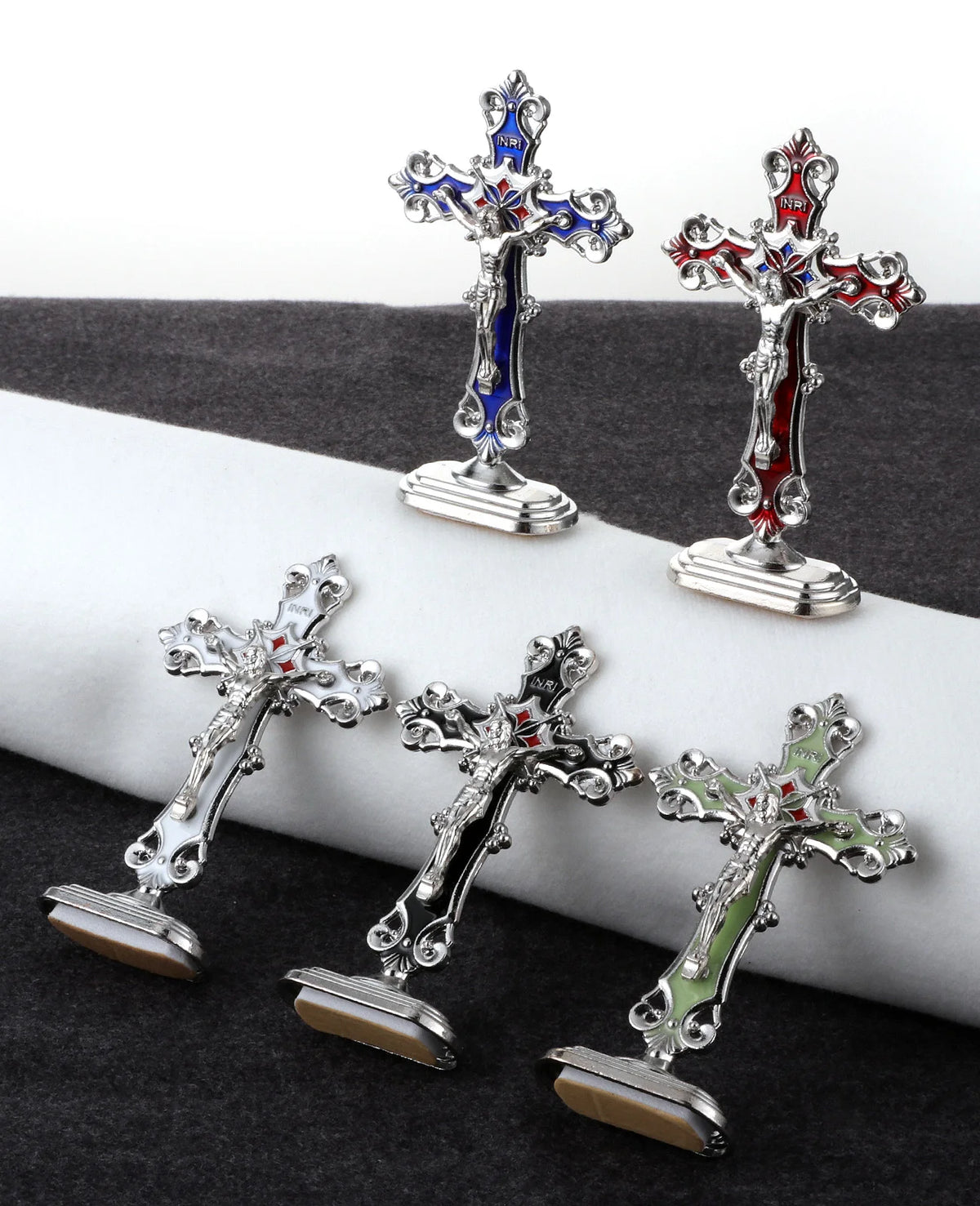 Three metal crucifix desk crosses with self-adhesive bases, featuring silver and blue enamel designs.