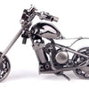 A handcrafted metal motorcycle model with chrome details and spoked wheels.