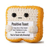 A handmade crochet toast shaped doll with a positive message card