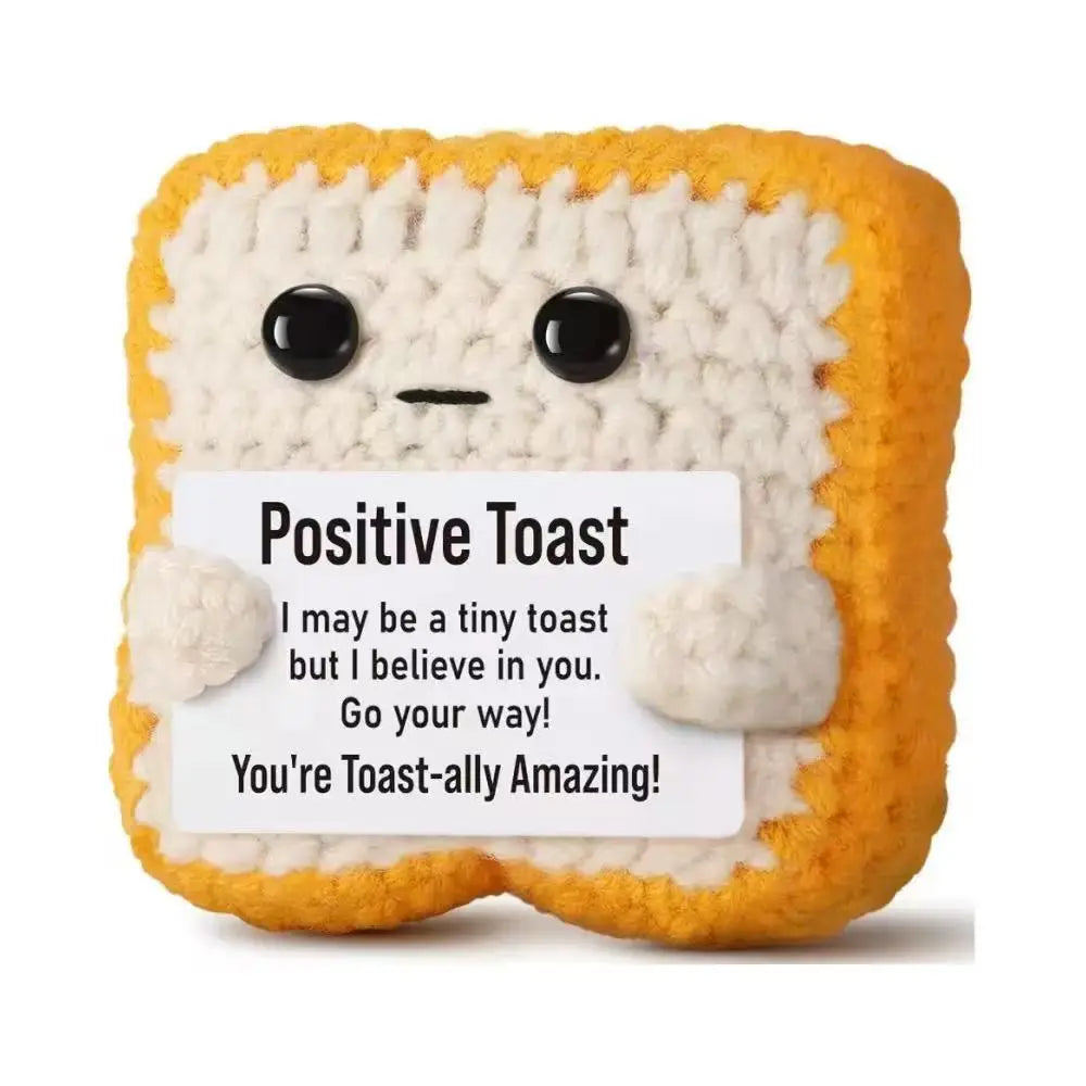 A handmade crochet toast shaped doll with a positive message card