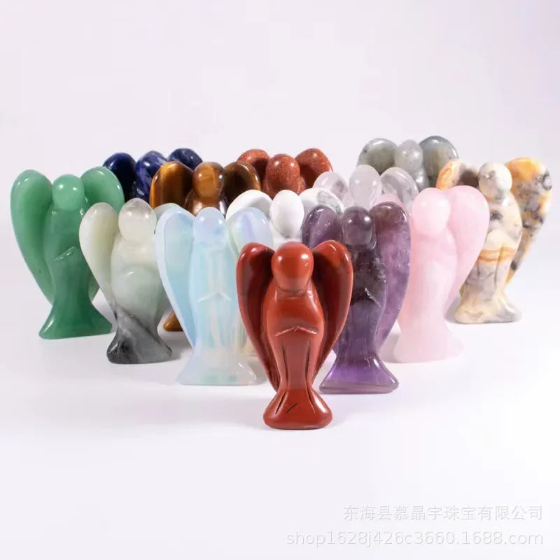 A collection of hand-carved angel crystal figurines in various colors and shades.