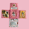 Handcrafted pocket devotional with a cross-shaped pouch in pink fabric featuring religious imagery.