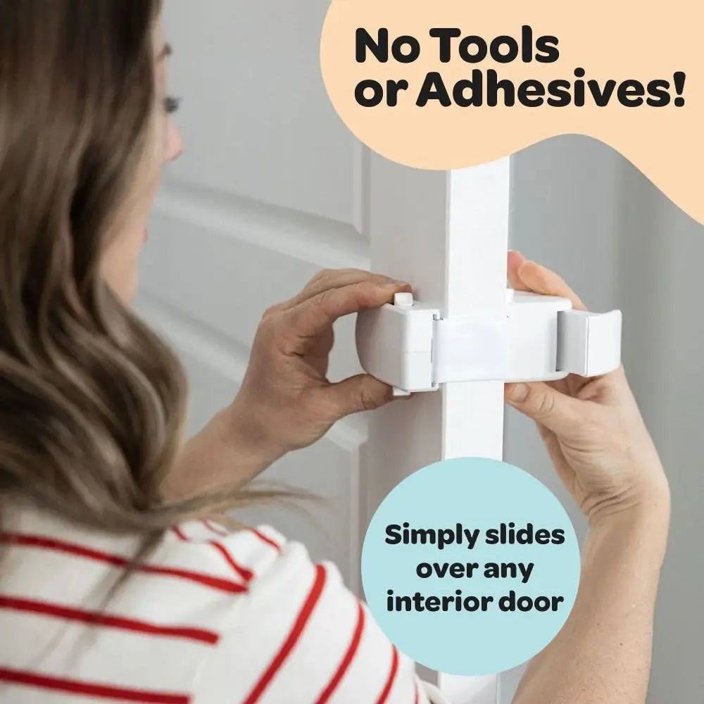 A person is using a white door lock that simply slides over an interior door without tools or adhesives.