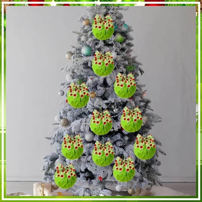 A Christmas tree decorated with twelve faux fur ornaments featuring green balls and bows.