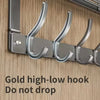 A close-up of a gold high-low hook over-the-door organizer rack designed to prevent items from dropping.
