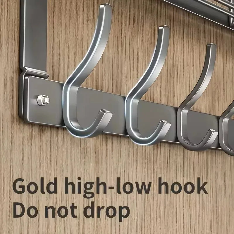 A close-up of a gold high-low hook over-the-door organizer rack designed to prevent items from dropping.