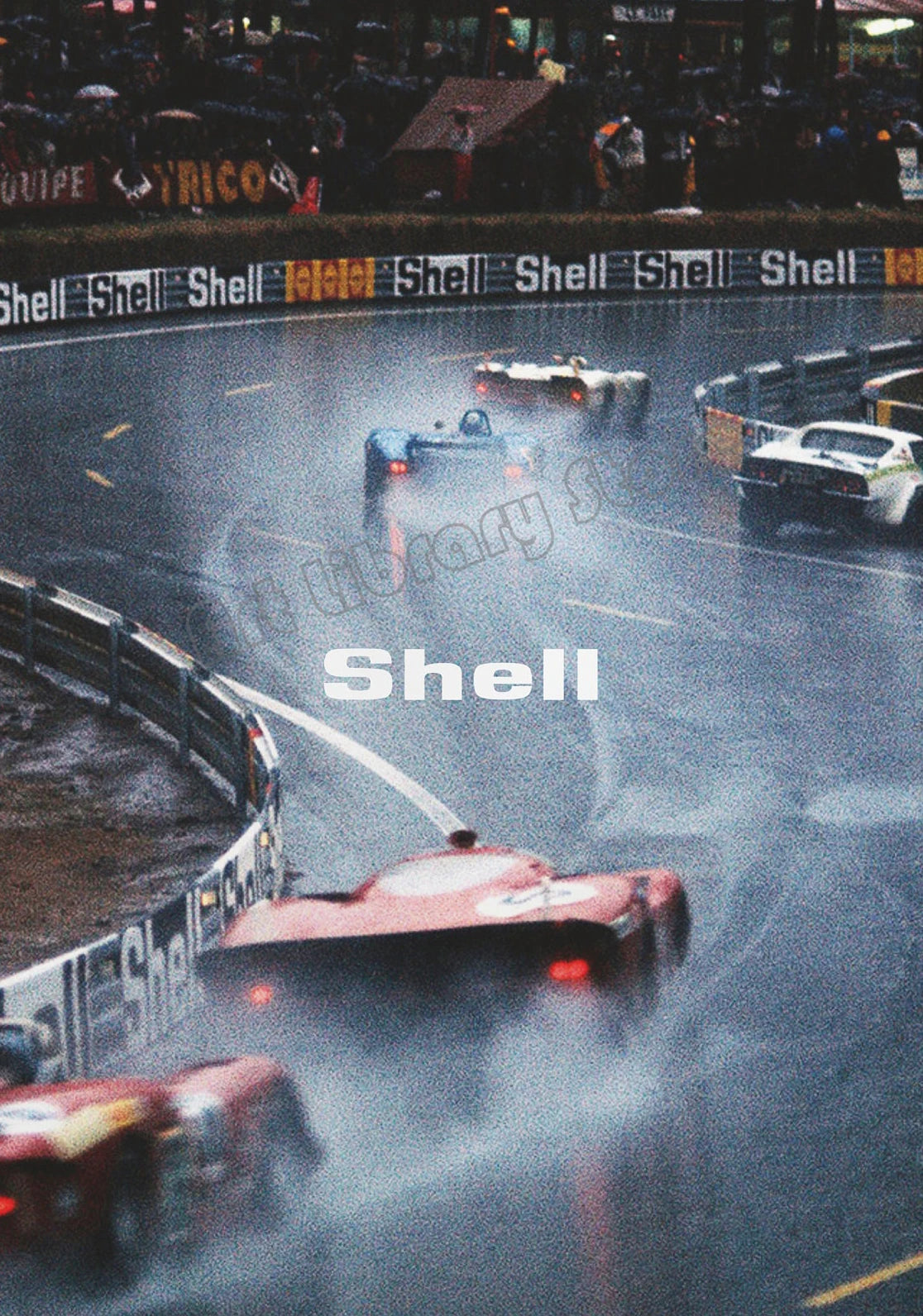 A vintage Formula 1 race scene featuring several cars on a track with Shell branding visible.