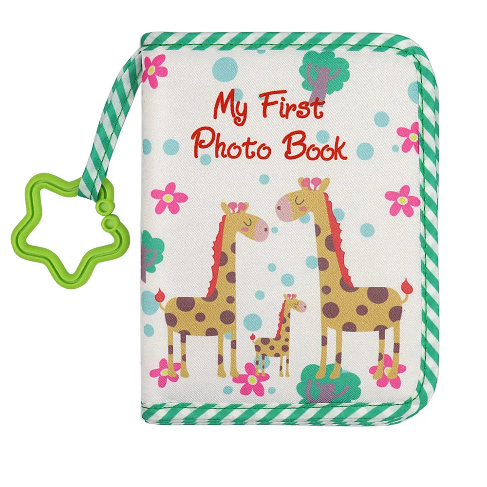 A light-colored photo book with a green striped strap featuring two stylized baby giraffes and pink flowers.