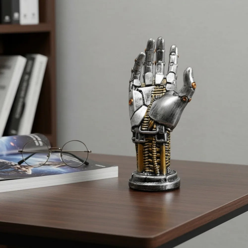 A detailed metal hand-shaped storage organizer for a 3D gamepad or controller, displayed on a wooden surface.