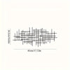 Black metal prayer cross wall art featuring an intricate grid design.