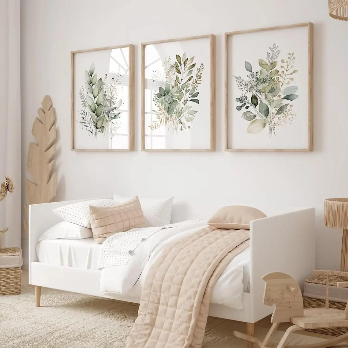 Three framed watercolor botanical prints featuring wild flowers and greenery on a white wall.