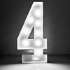 A bright white light-up marquee number sign shaped like the numeral four standing on a surface.