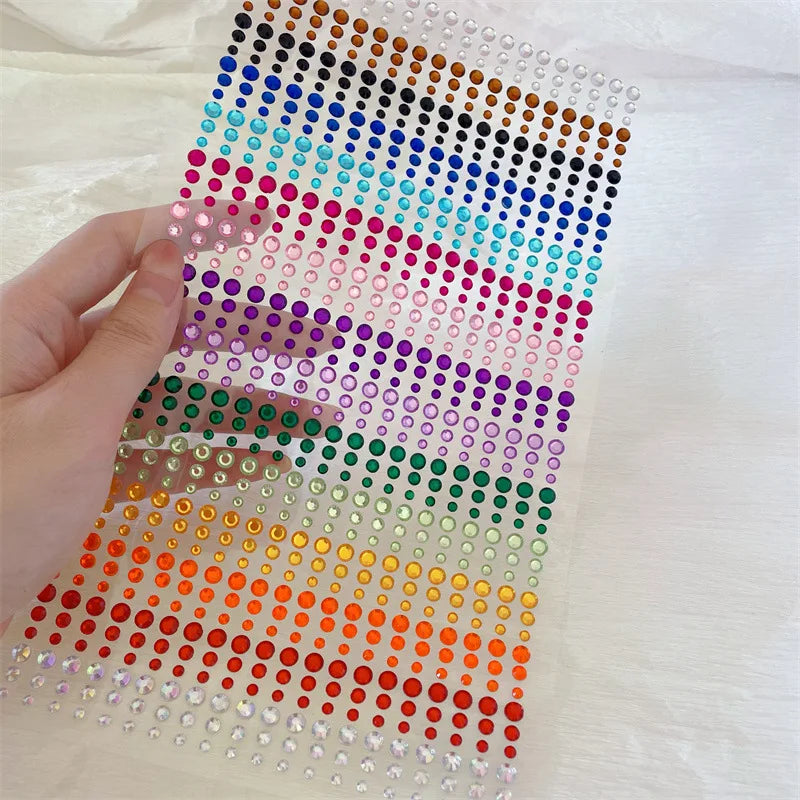 A grid of colorful glitter gems arranged in rows and columns for facial tattoos.